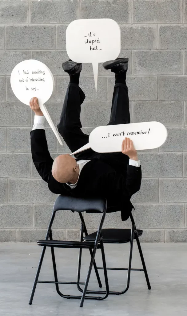 "I had something interesting to say...", 1995. Wax, wood, clothes, chairs. 180 x 110 x 130 cm.