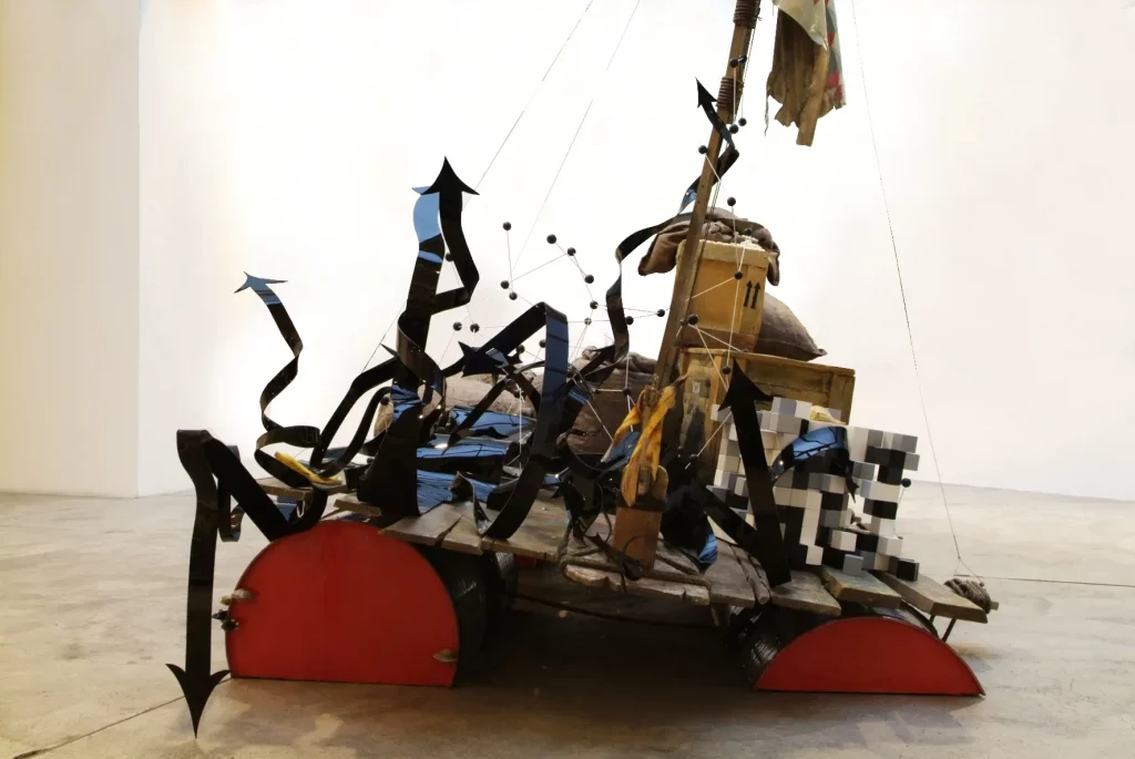 "Le Cockpit", 2007. Résine peinte et Barils. 309 x 465 x 225 cm.